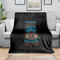 Black skull tiki graphic blanket with colorful text design, laid on sofa