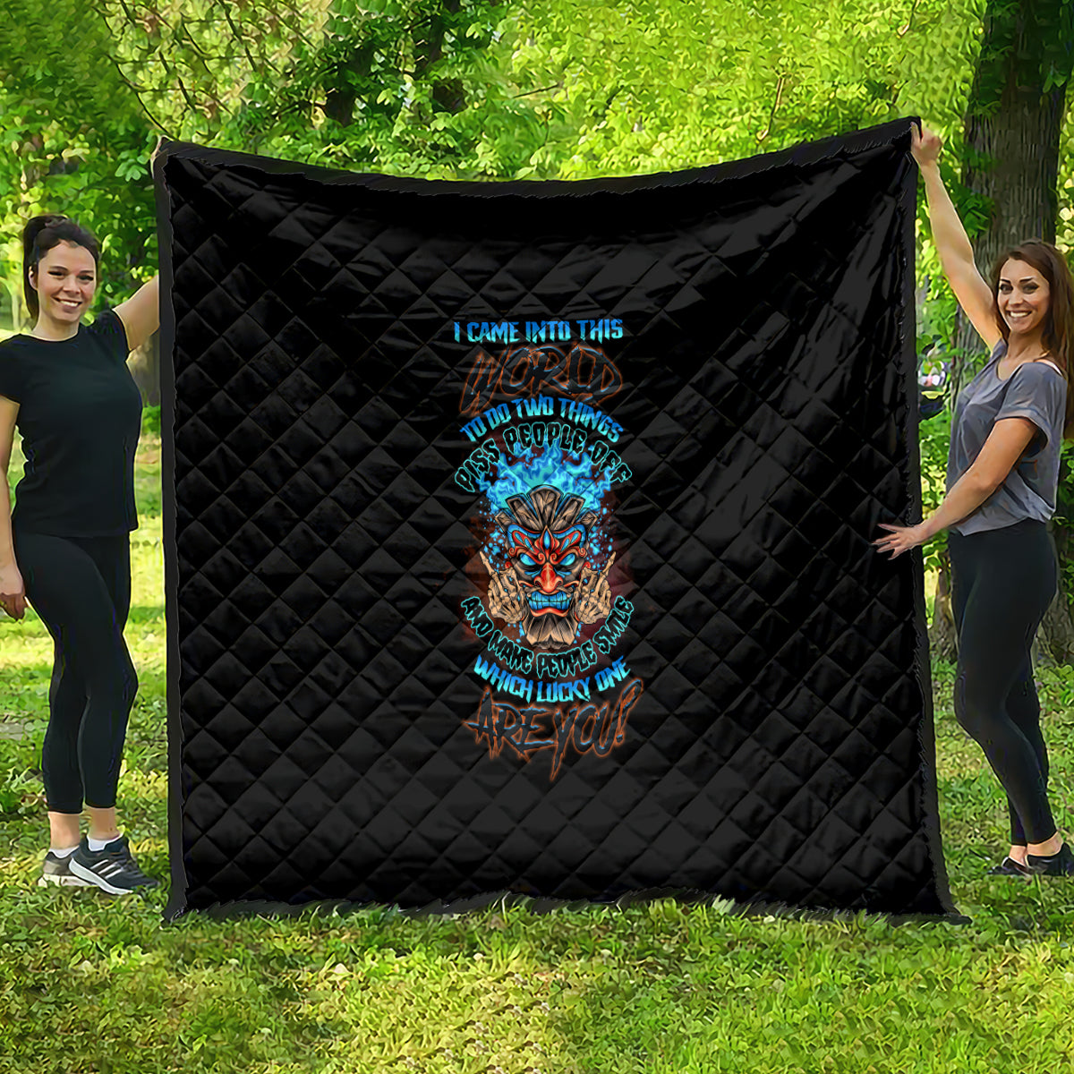 Black quilt with diamond quilting and colorful tiki skull graphic centered