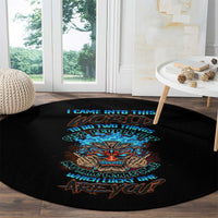 Round black rug with colorful tiki skull print and stacked slogan lines