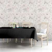 Skull tiki printed tablecloth with multicolor border, draped over a dining table