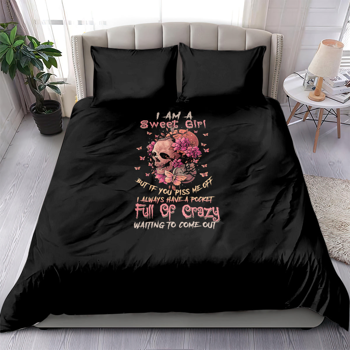 Black bedding set with pink floral skull graphic and text on duvet and pillowcases