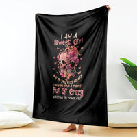 Black fleece throw blanket with flower skull face and pink slogan text
