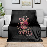Black fleece blanket with flower skull graphic and colorful slogan print