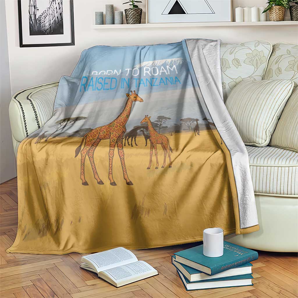 Safari giraffe blanket with blue and gold tones, “Born to Roam Raised in Tanzania” text