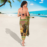 African sarong worn as wrap, kente motifs with lion portrait on green and gold ground