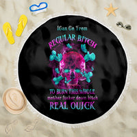 Round black beach blanket with neon skull graphic and fringe trim