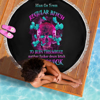 Round black beach blanket with neon skull graphic, fringe edge; dog lying on it