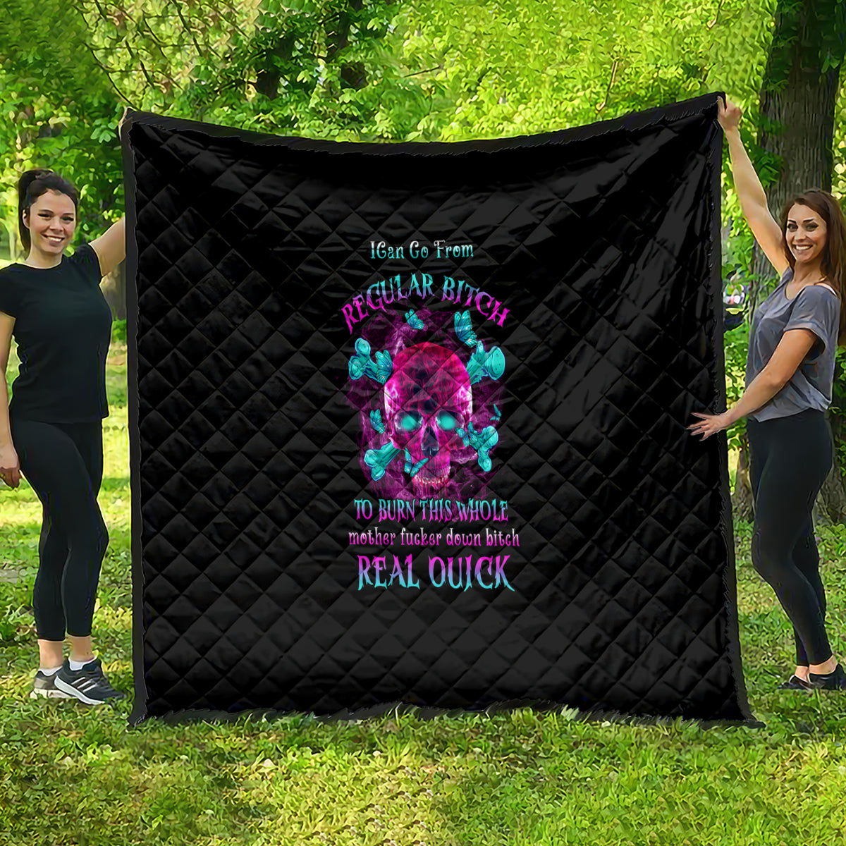Black quilt with diamond stitching and colorful skull graphic centered on the face