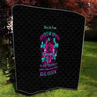 Black quilt blanket with quilted diamond texture and colorful skull print, angled view