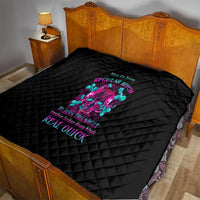Black quilt bedspread with diamond stitching and colorful skull graphic in the center