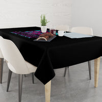 Black tablecloth draped on a dining table with hanging corner fabric