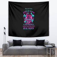 Black tapestry wall hanging with neon-style skull graphic and phrase text