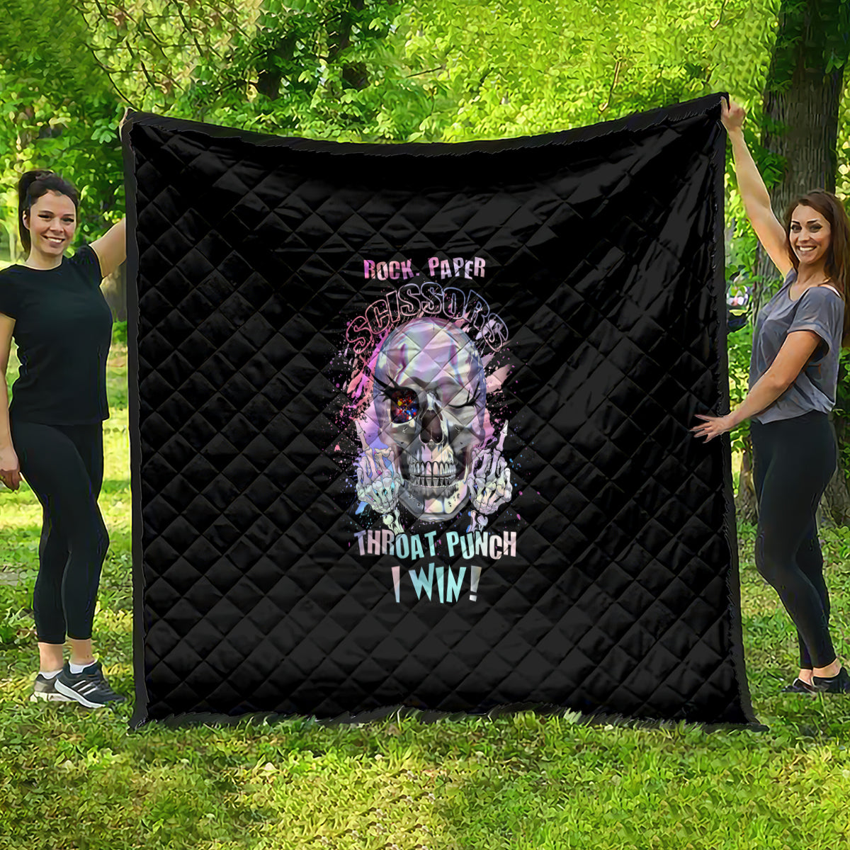 Black quilted throw blanket with colorful skull graphic and stylized text