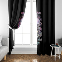 Black window curtain panels framing a white door-window, with colorful skull “Win!” print
