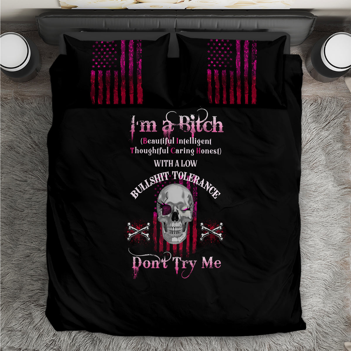 Black duvet bedding set with centered skull graphic and two striped accent pillows