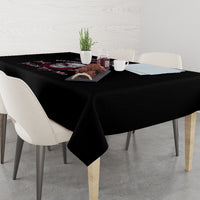 Black tablecloth on dining table with pink-and-black graphic detail at one end
