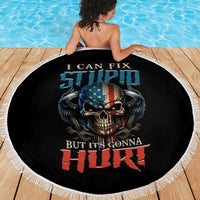 Round black beach blanket shown laid out, skull and patriotic text print, fringed