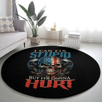 Round black carpet laid on floor featuring skull, wings, and bold patriotic lettering