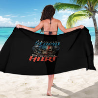 Black printed sarong with skull graphic and bold text, draped by beach model