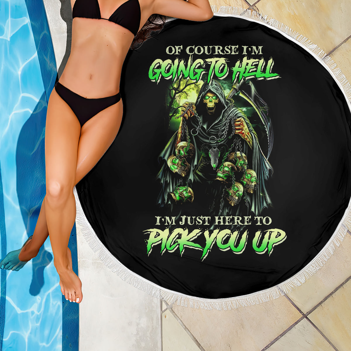 Round black beach blanket with green skull graphic and white fringed edge, close view