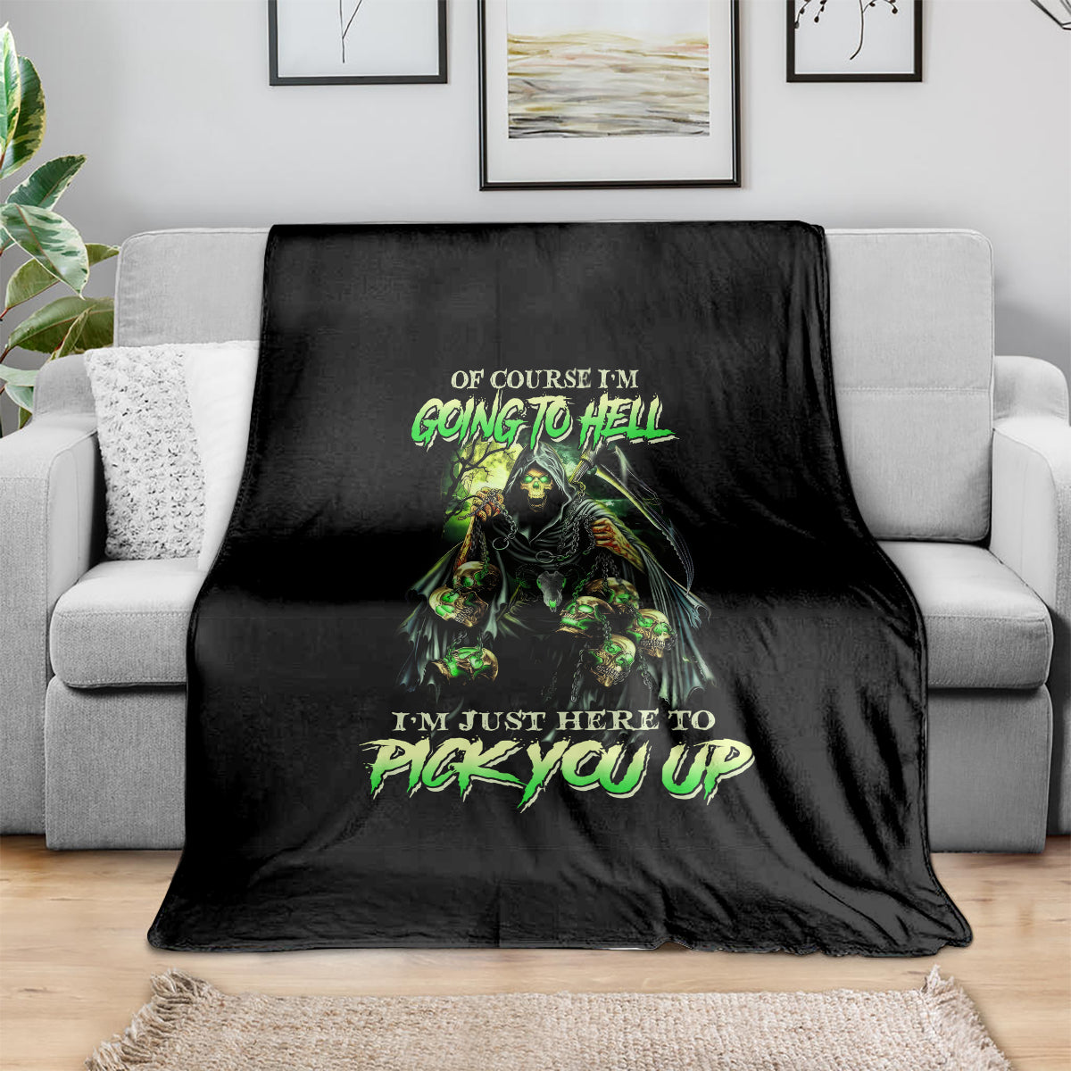 Black skull graphic blanket with neon green lettering, draped over a sofa arm