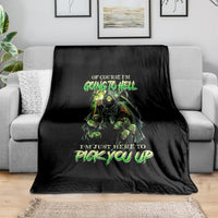 Black skull graphic blanket with neon green lettering, draped over a sofa arm