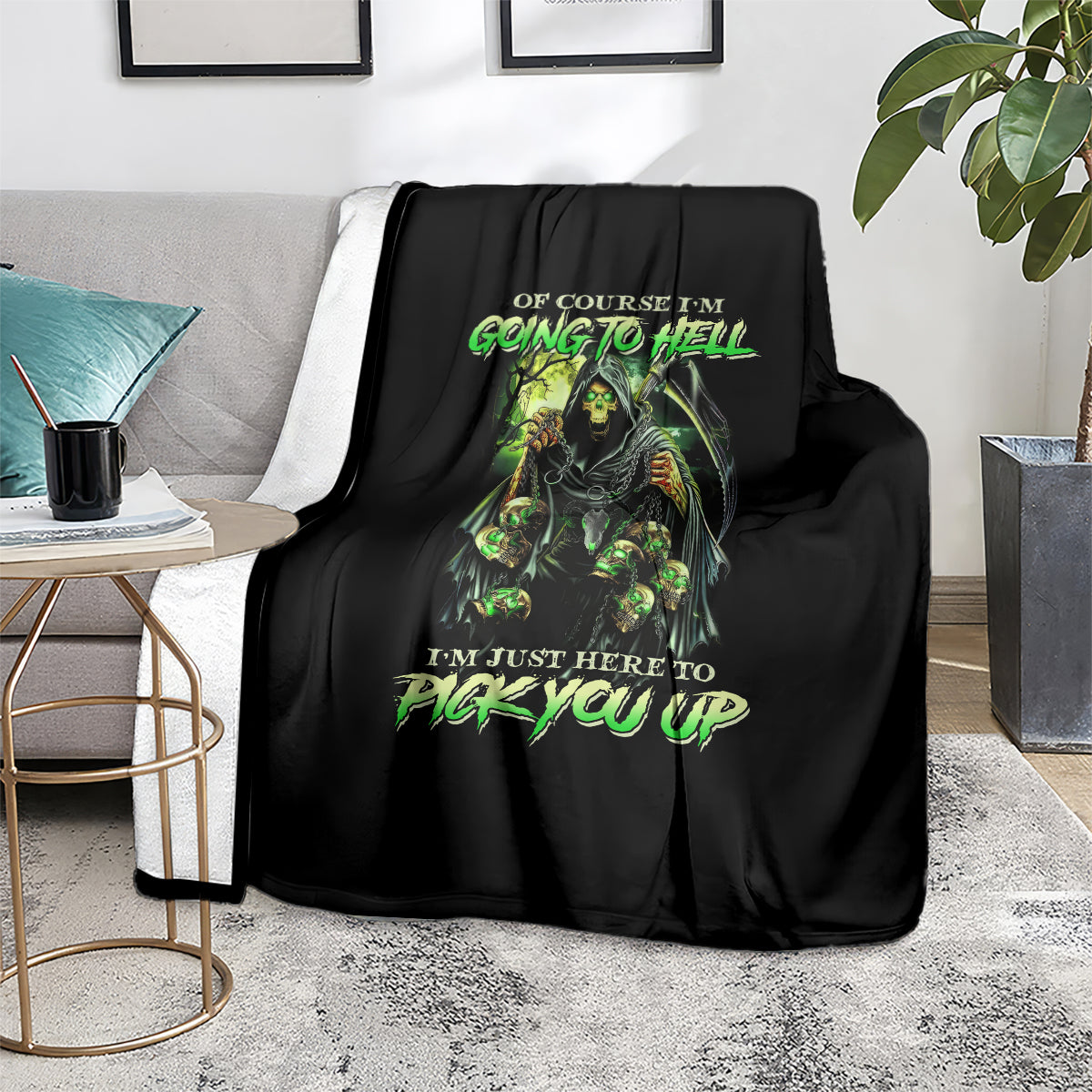 Black skull graphic blanket with neon green lettering, laid across a sofa