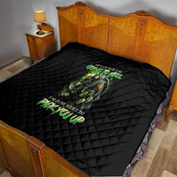 Black quilt blanket with green skull and neon-style lettering on quilted diamonds