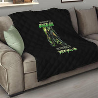 Black quilt blanket with diamond quilting and centered green skull text graphic