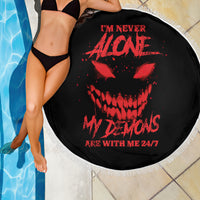 Black round beach blanket with red skull graphic and white fringe edge, 24/7 text