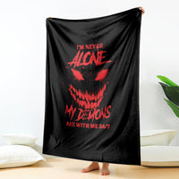 Black blanket with red skull graphic draped, showing full design