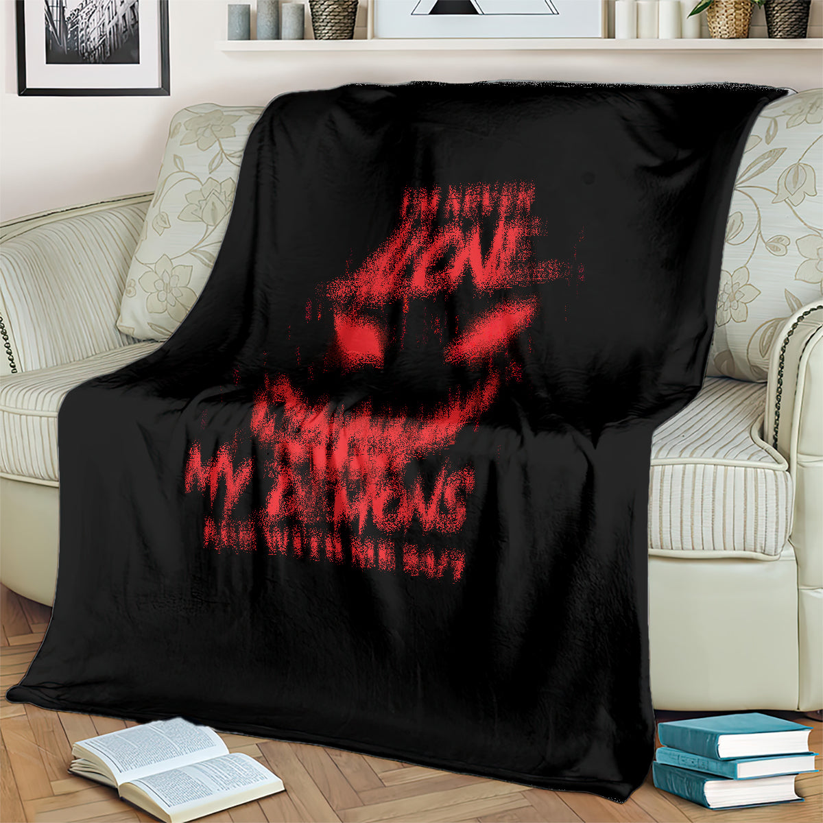 Black throw blanket with red skull and text graphic covering a sofa