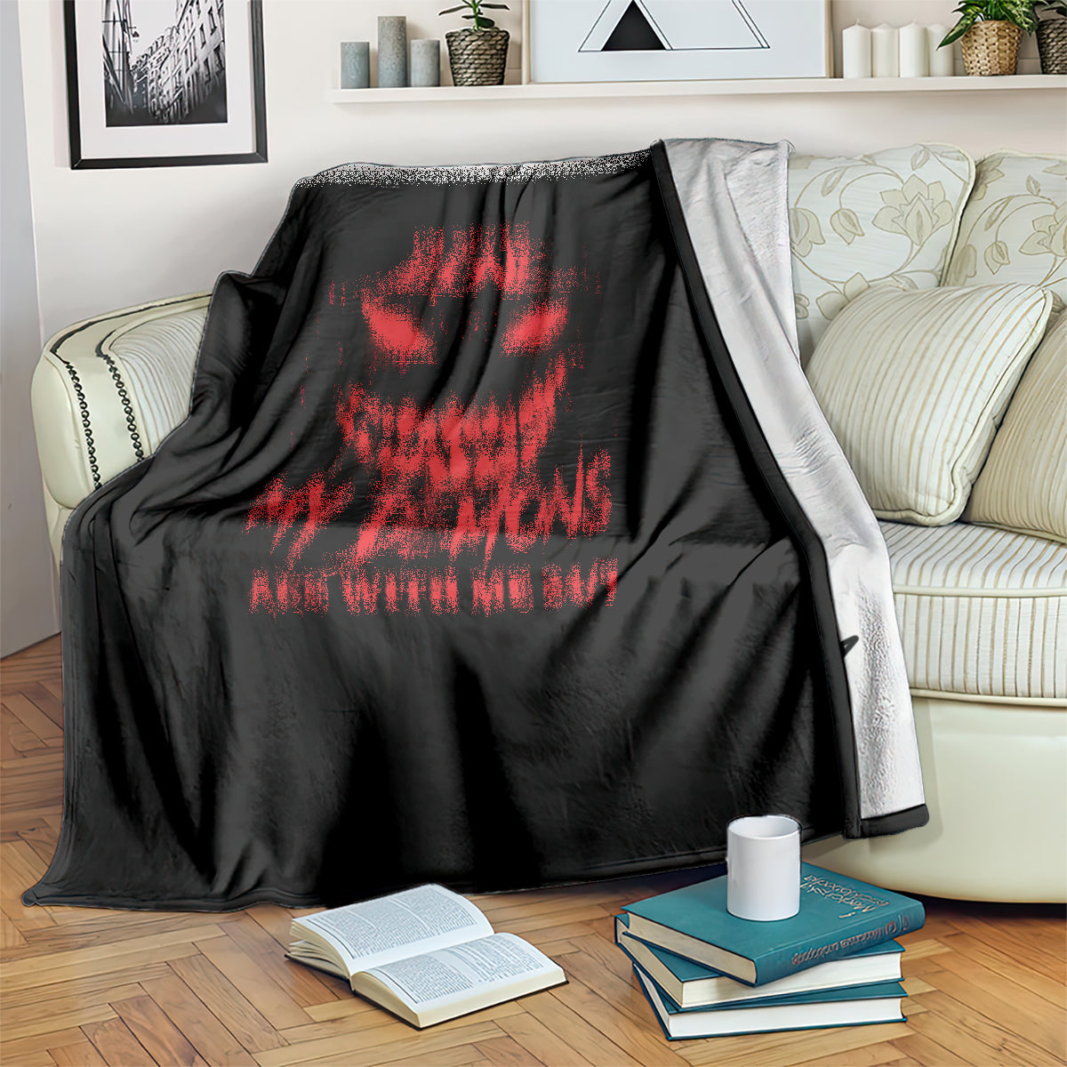 Black blanket with red skull graphic draped over sofa back and arm