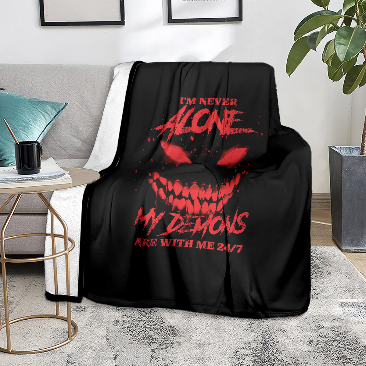 Black throw blanket with red skull and text graphic on a couch