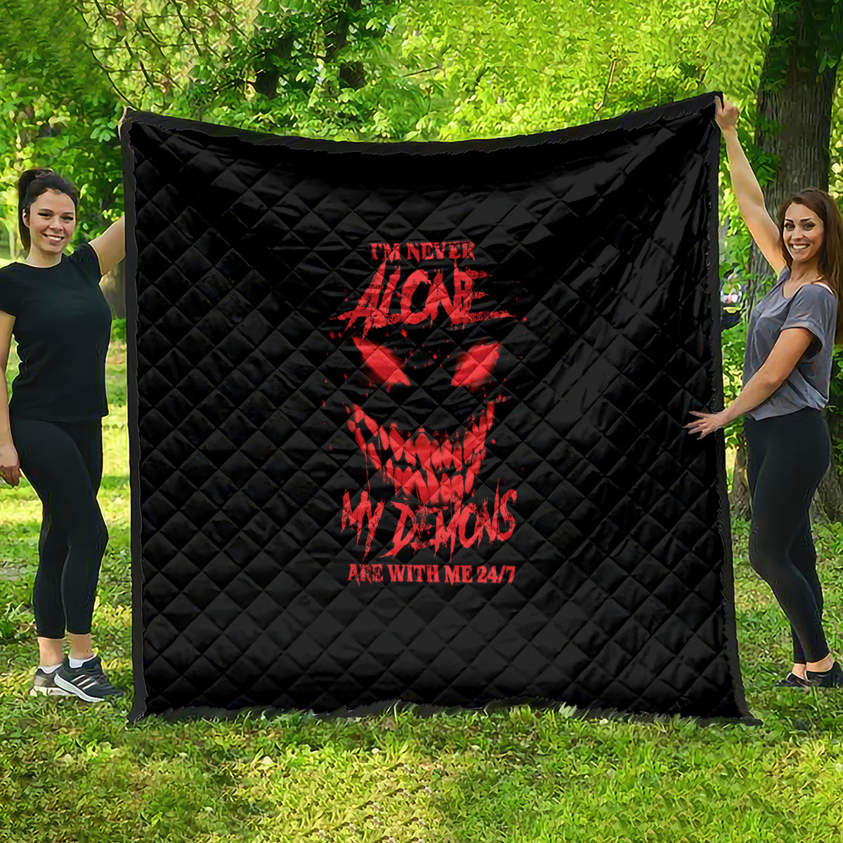 Black quilt blanket with red demon graphic and text, diamond quilt pattern
