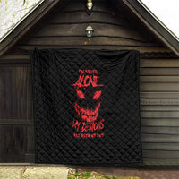 Black quilt blanket with red demon face graphic and text, hanging on wall