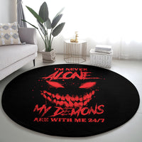 Round black carpet with red demon graphic and “24/7” slogan text