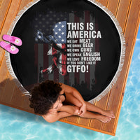 Round patriotic beach blanket, black with skull and American flag graphic, white fringe