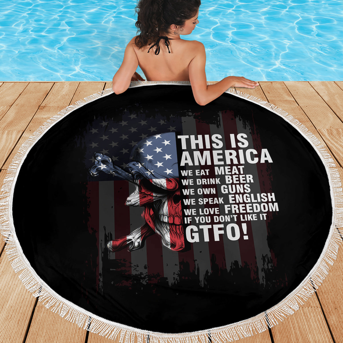 Round patriotic beach blanket, black skull-and-flag design with white fringe edge