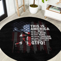 Black round patriotic rug featuring skull artwork, stars, and “THIS IS AMERICA” quote