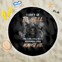 Round black beach blanket with white fringe and skull reaper graphic, full design visible