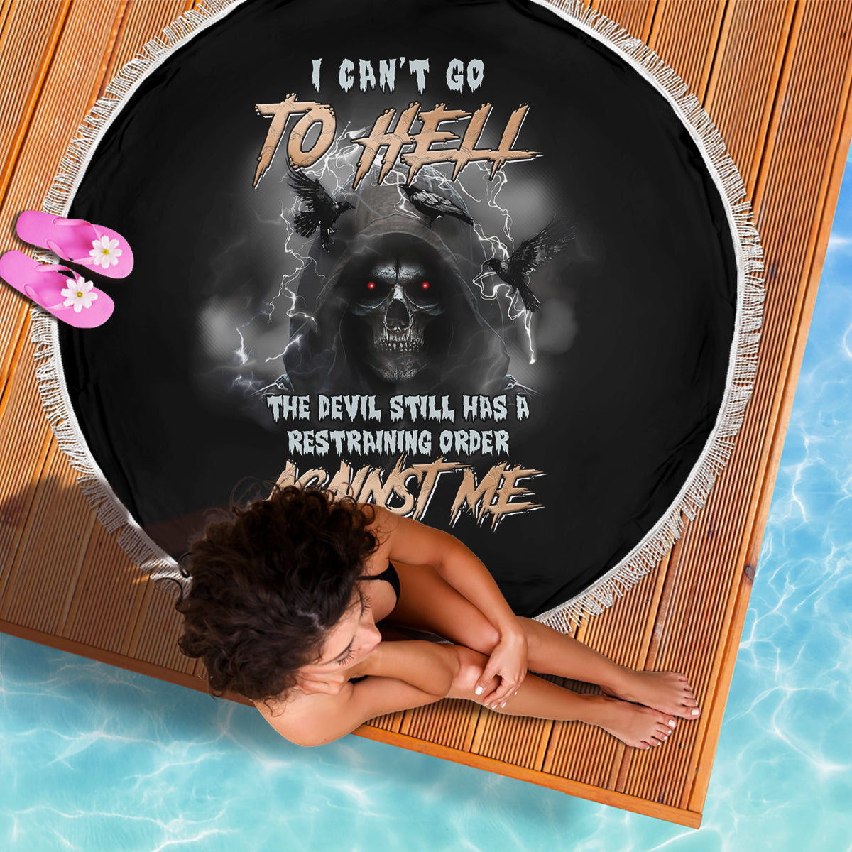 Round black beach blanket with white fringe and skull reaper graphic center print