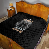 Black quilt draped over bed with diamond quilting and reaper skull graphic