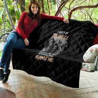 Black quilt held outdoors, diamond quilting, featuring reaper skull and slogan text