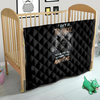 Black quilt in a crib with diamond quilting and reaper skull text design