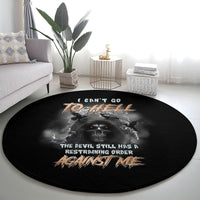 Black round carpet with skull and bat-wings print, text across the center