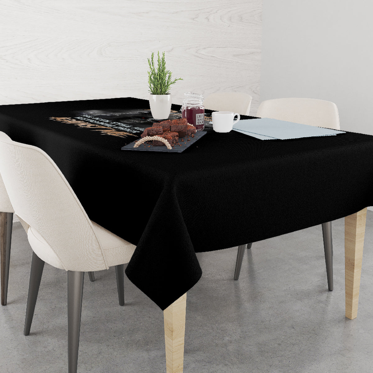 Black reaper graphic tablecloth over a dining table with plates and cups