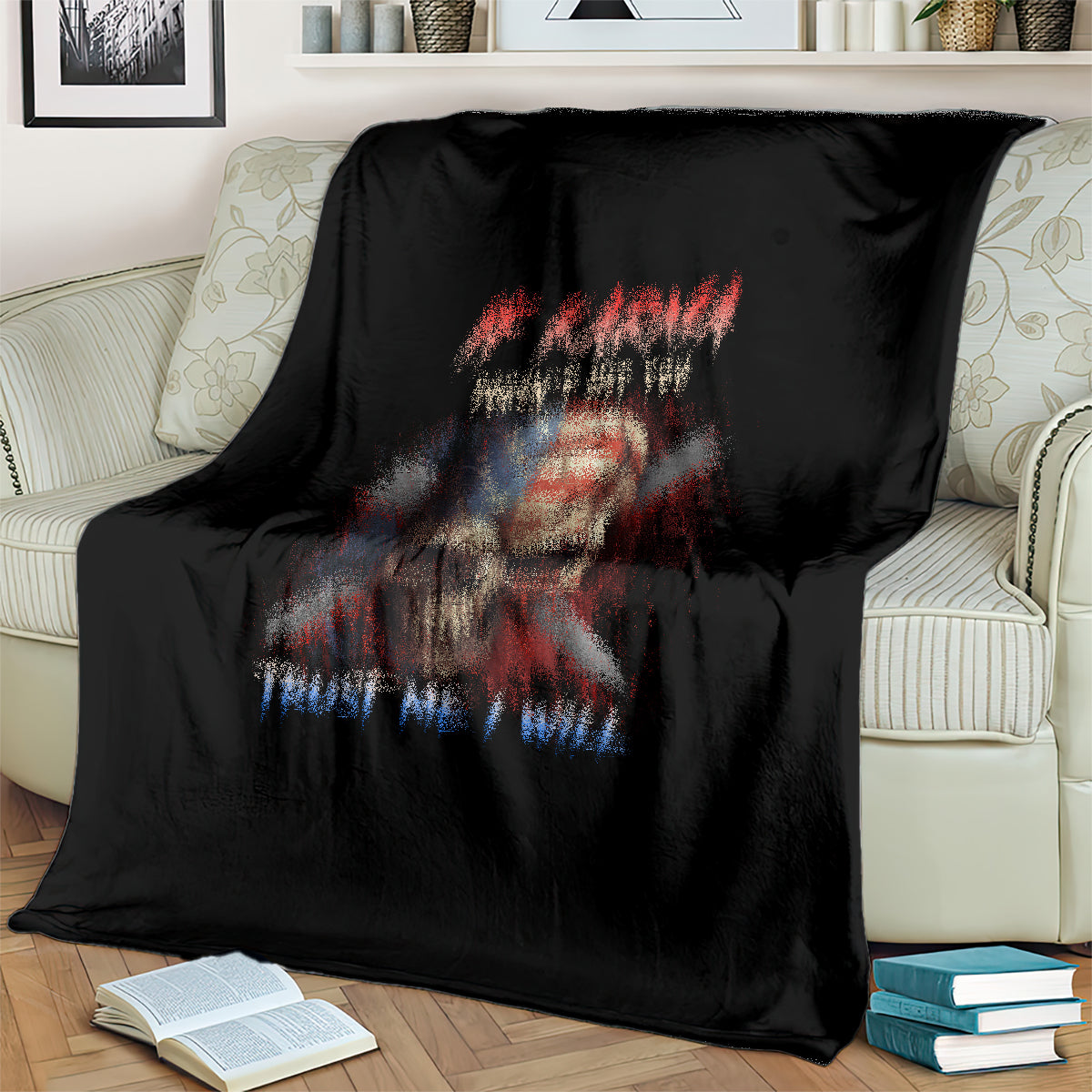 Black skull graphic throw blanket with patriotic headline, draped on sofa