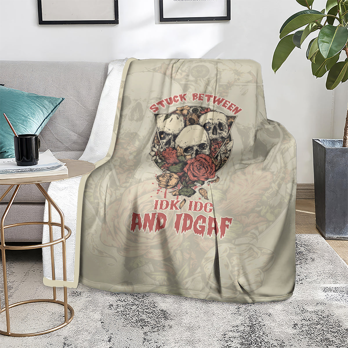 Beige skull blanket on sofa with red rose emblem and slogan lettering