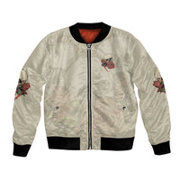 Cream bomber jacket with skull-and-rose patch, front zipper, black ribbed collar and cuffs